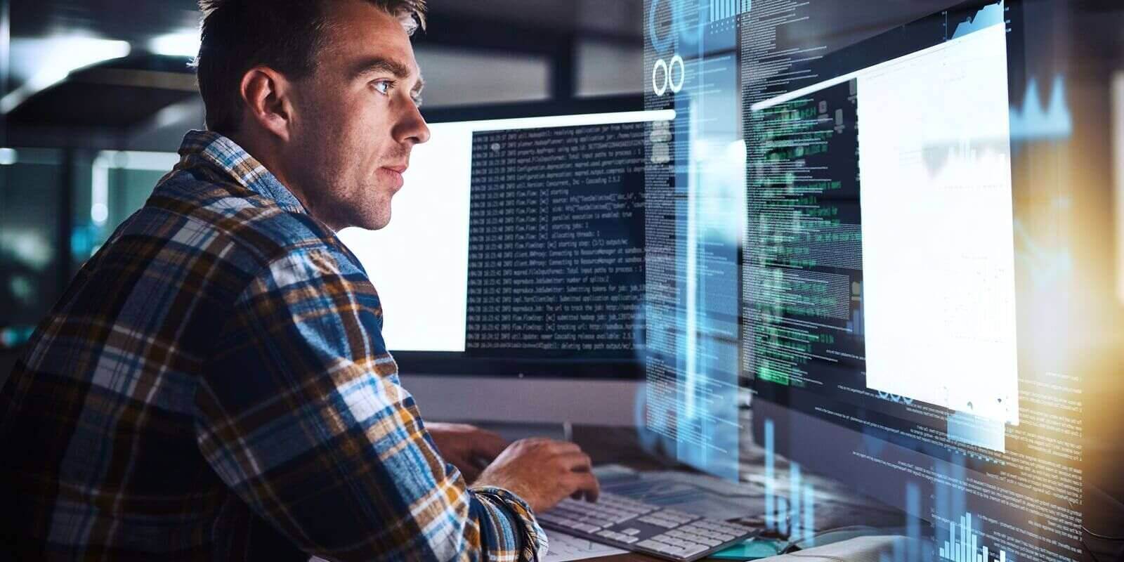 man and programmer code on computer screen with cybersecurity hologram