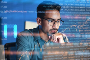 Computer, code hologram and man thinking of data analysis, night cybersecurity and software coding overlay. Programmer or person in glasses reading html script, programming or cybersecurity research.