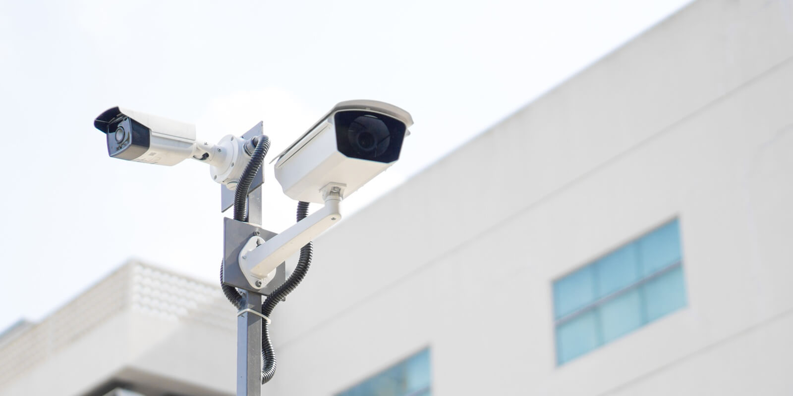 cctv surveillance security camera video equipment on pole outdoor building safety system area control and copy space