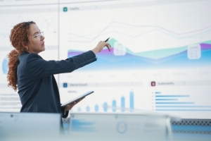 professional woman standing and analyzing data while conducting a cybersecurity audit