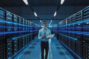IT professional planning in a blue-lit server room for Decommissioning Legacy Racks.