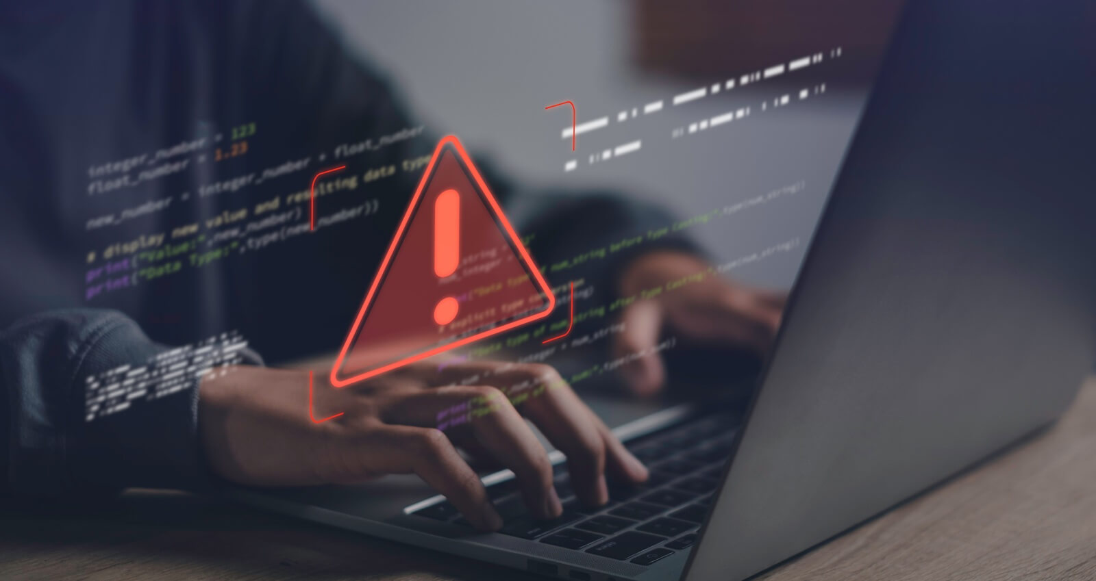 close-up of hands typing on laptop with warning error icon and code overlay