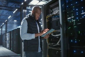 data center technician inspects server racks