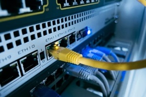 network switch with yellow ethernet cable connected to port