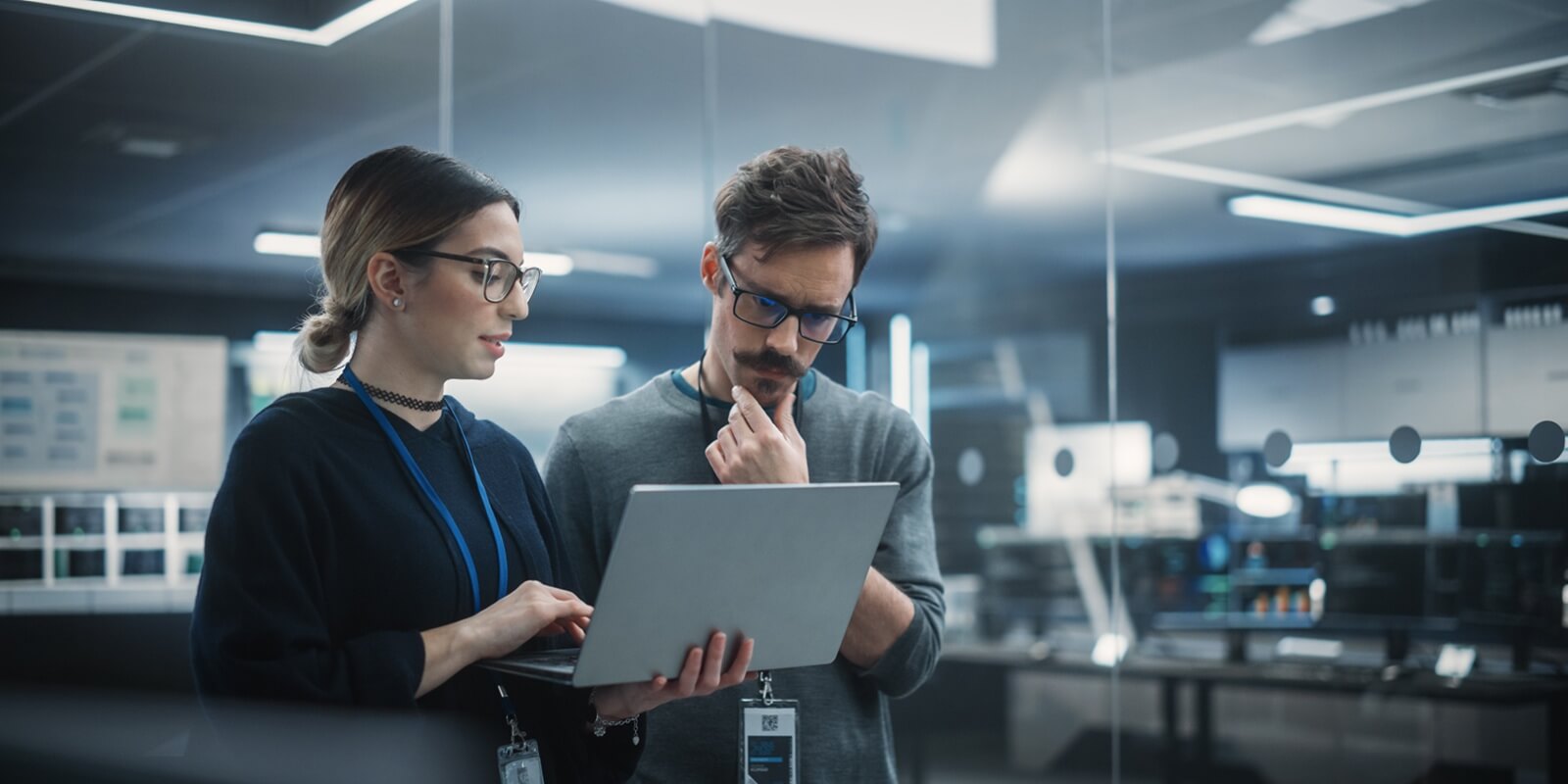 multicultural chief technology officer talking to software developer