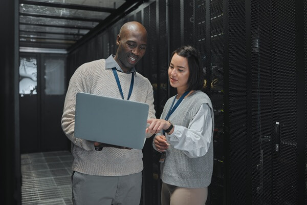 black man and woman with laptop, servers and cyber security for connection, data analytics and conversation