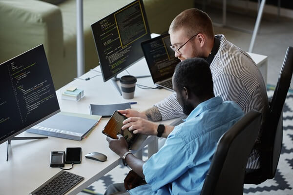 colleagues working together on software development in modern tech workspace
