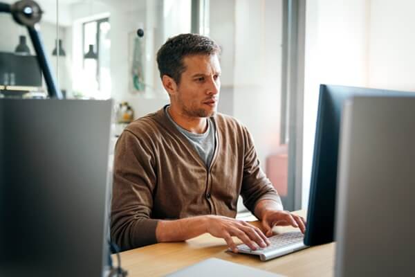 designer working at office comparing mobile and desktop website versions