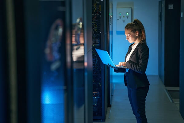 engineer working in server room at modern data center