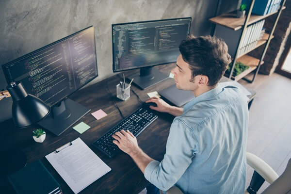 high angle view portrait of his he nice attractive focused skilled geek guy typing bug track report cyberspace security