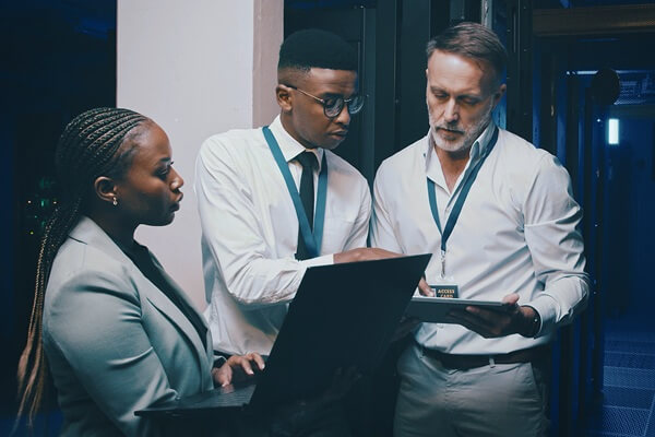 it support and people with tech in server room for cybersecurity, diagnostics and network