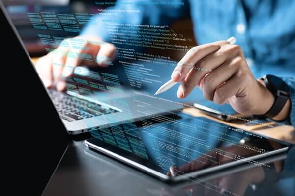 professional working with digital tablet and writing computer code language
