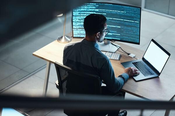 programmer and coding at night on laptop mockup screen for networking