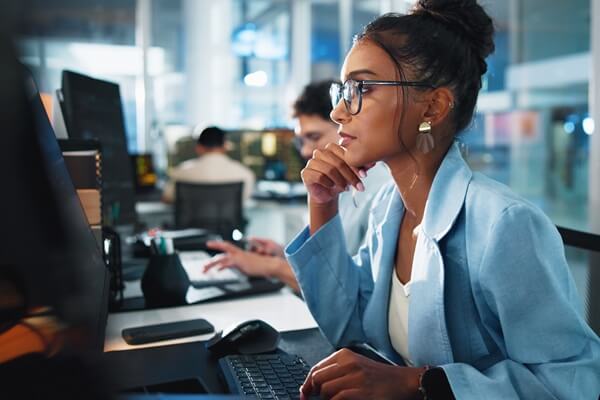 programmer and woman with computer, office and serious for project on website, reading and online
