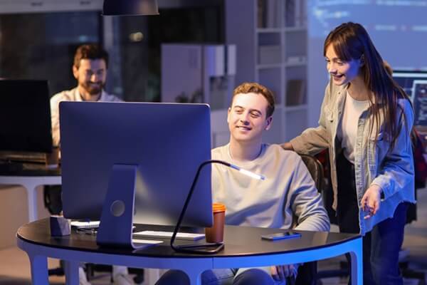 programmer working with his colleague in office at night