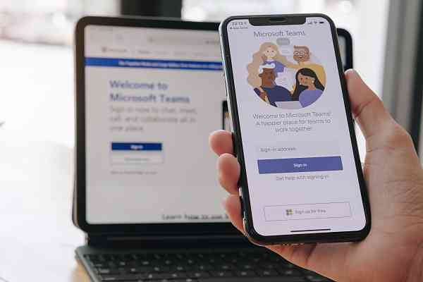 employee using and downloading microsoft teams on laptop and mobile