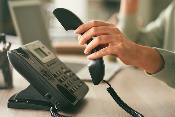 headset and dialing a telephone in call center office concept
