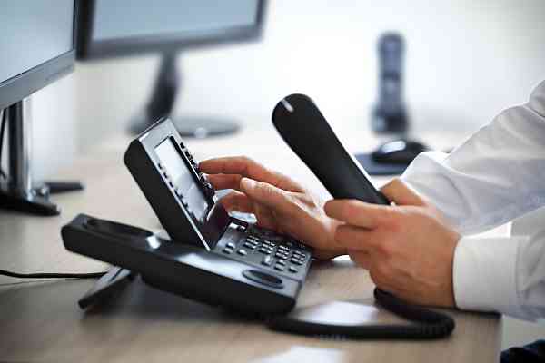 person using office land phone