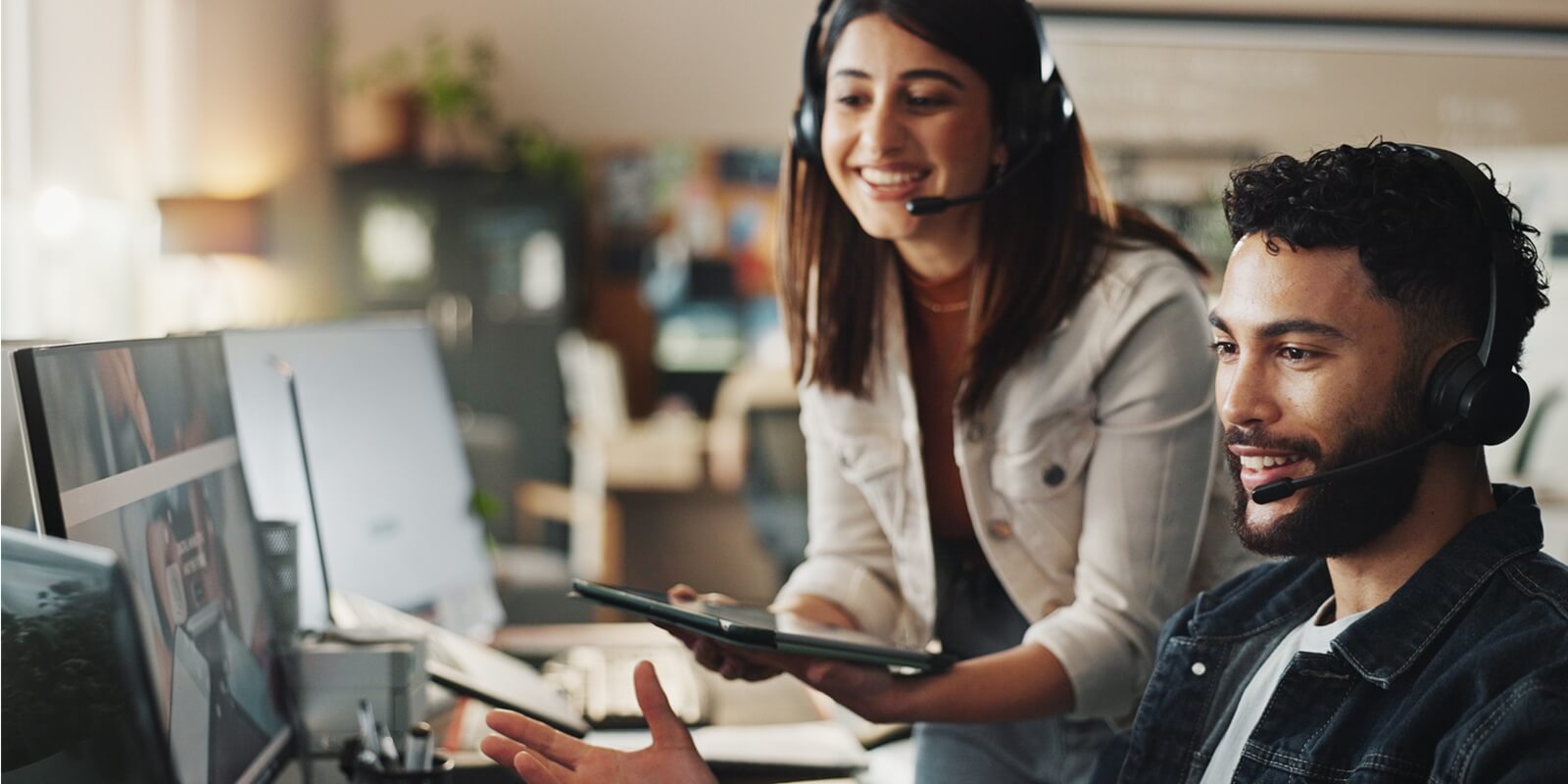 woman and happy man in tech support with headset, online help and website application